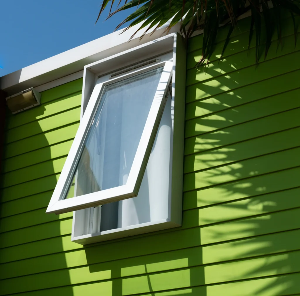 green mobilhome window with palm