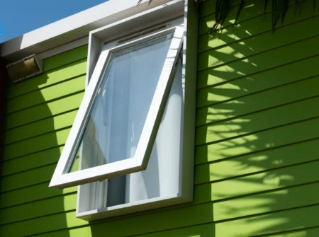 green mobilhome window with palm