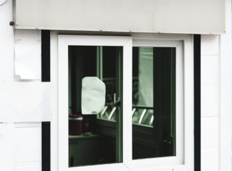 a white shop signage mockup above a shop window