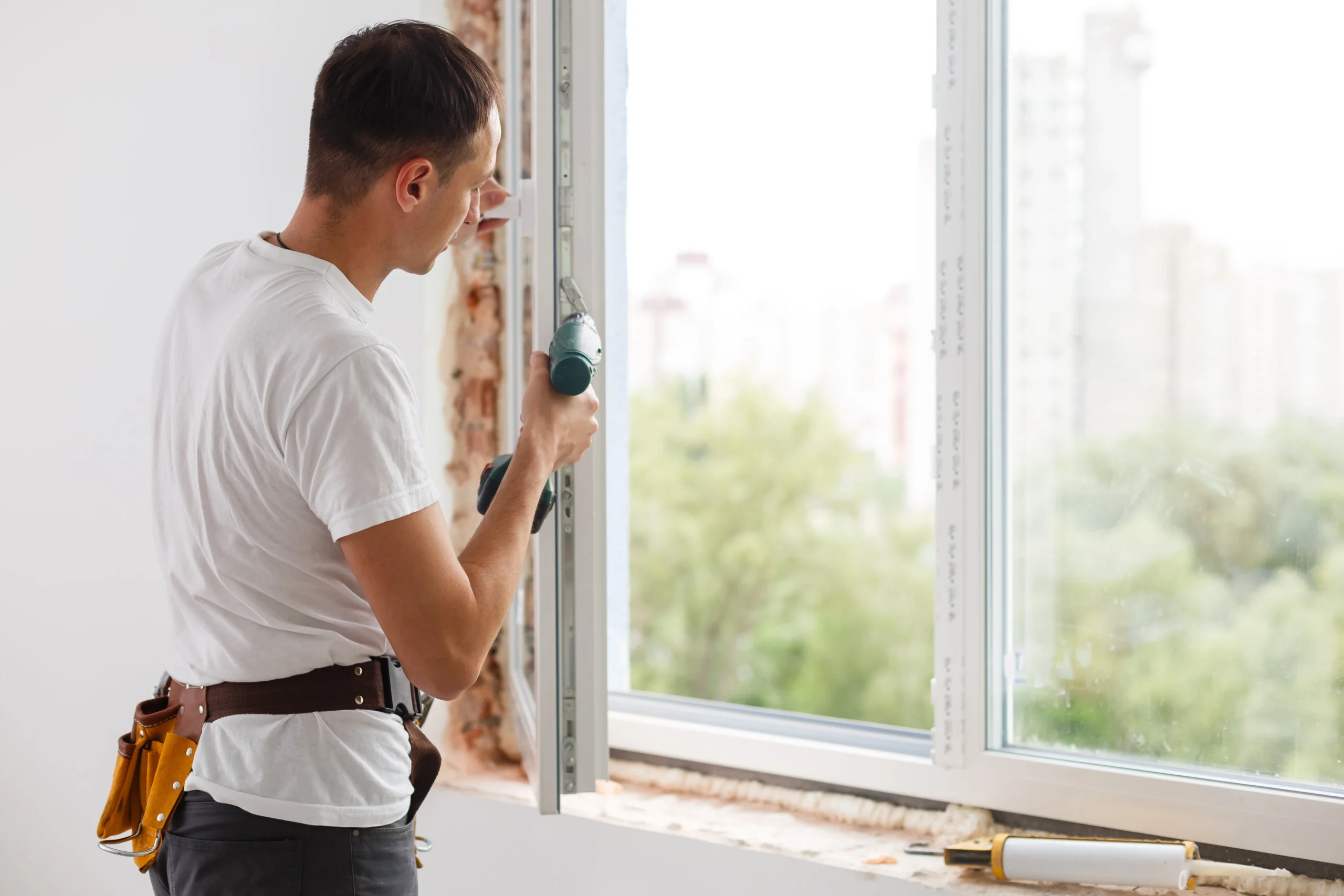 young handyman repair window wit